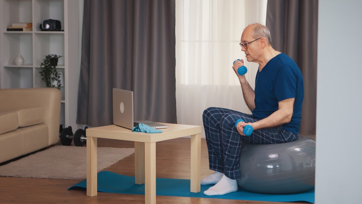 Senior man training in living room