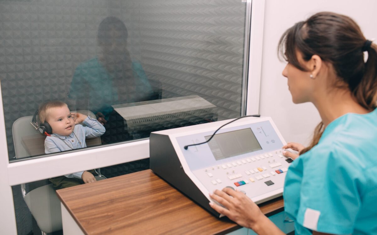 little boy during the hearing exam in the audiologist's office
